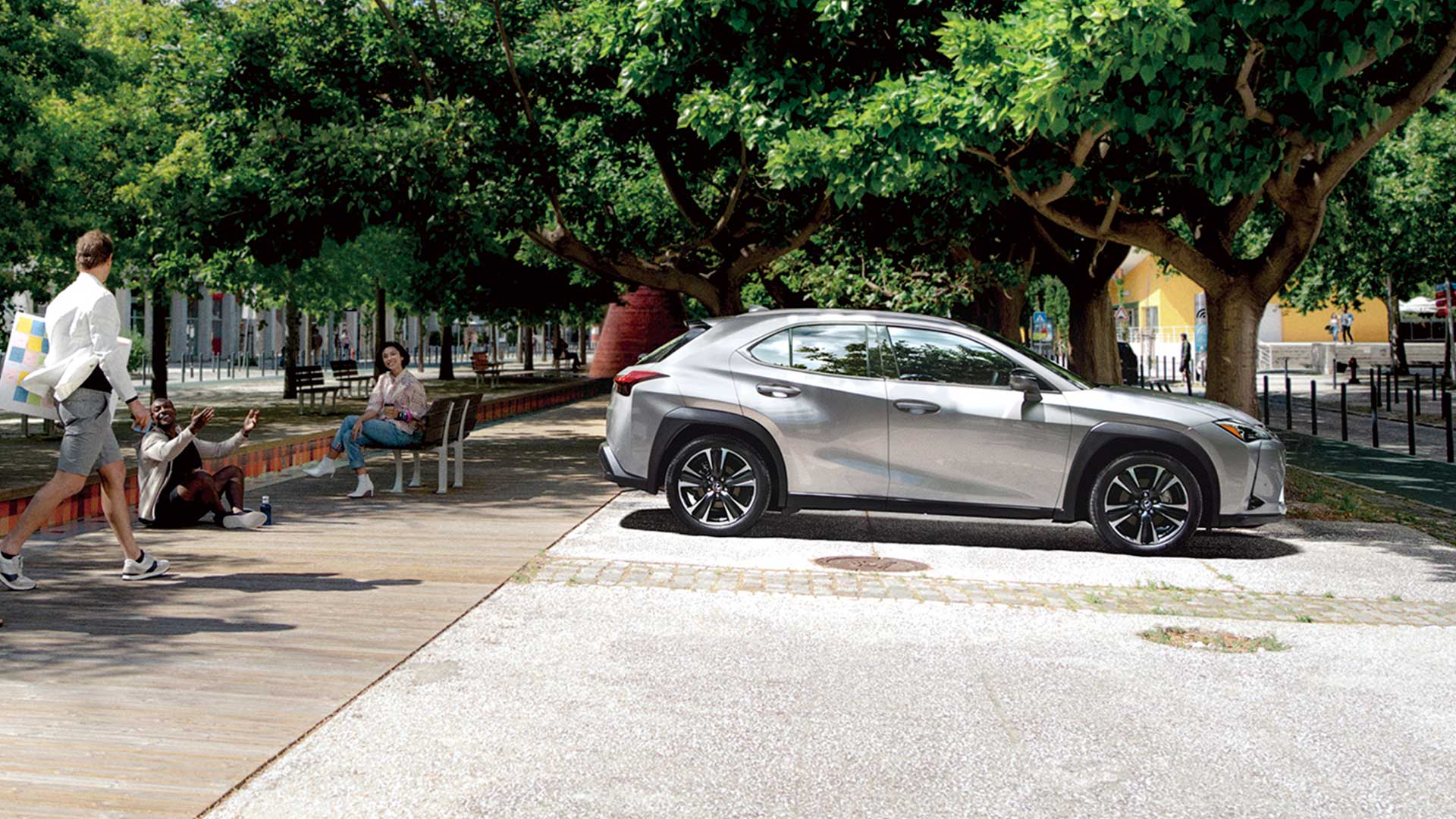 A man walks towards a Lexus UX